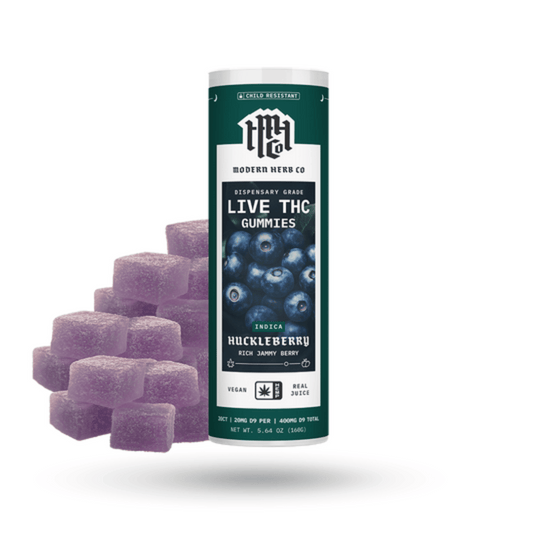 Modern Herb Co. Knockout Huckleberry Indica gummies in a dark green tube with rich purple cubes, infused with full-spectrum live resin for deep relaxation.